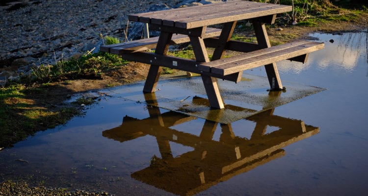 Picnic bench in puddle